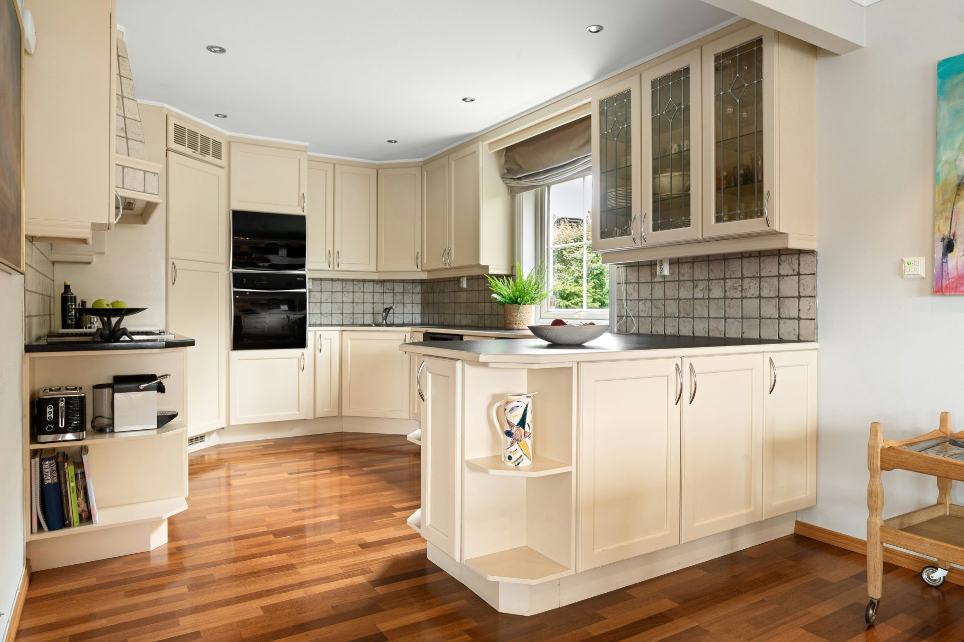A kitchen with a wooden floor and white cabinets