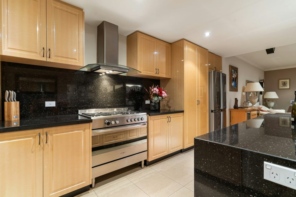 A kitchen with a stove, sink, and refrigerator