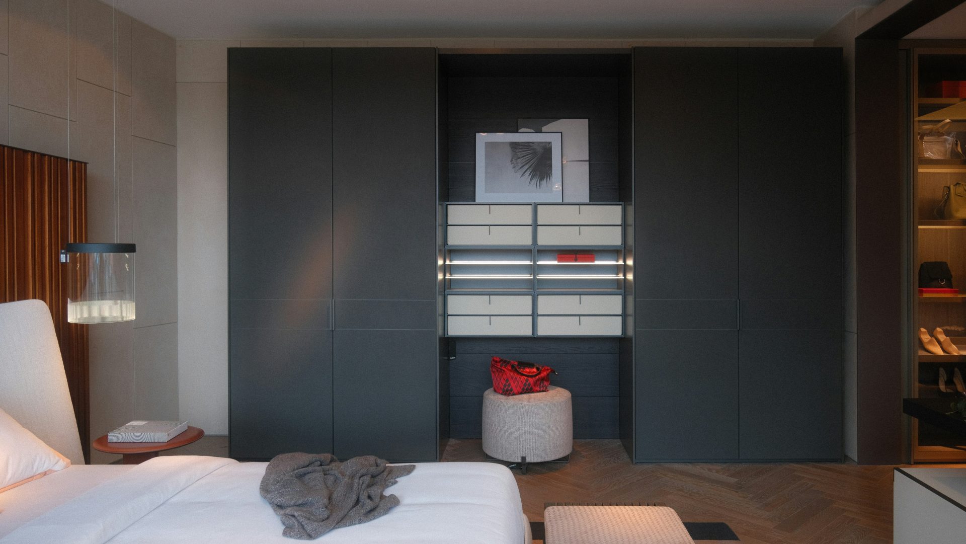 A bedroom with a white bed and a gray wall